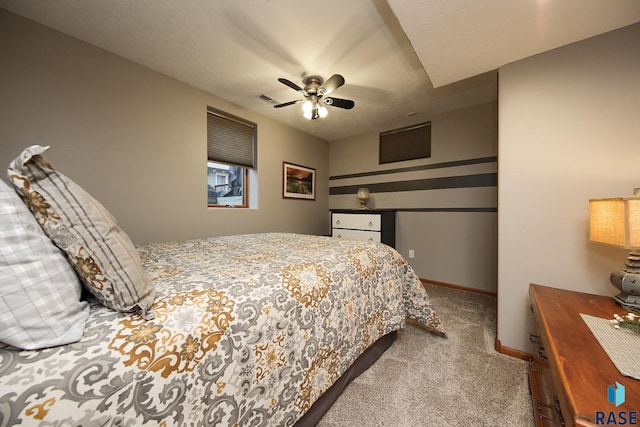 bedroom with a ceiling fan, carpet flooring, visible vents, and baseboards