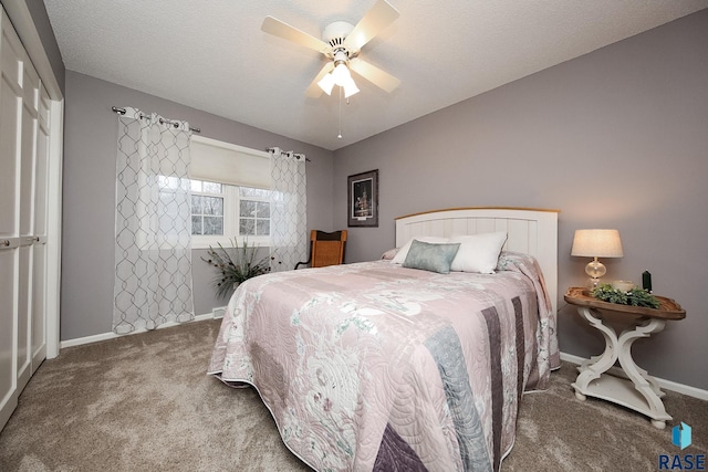 bedroom with a textured ceiling, carpet flooring, a ceiling fan, and baseboards