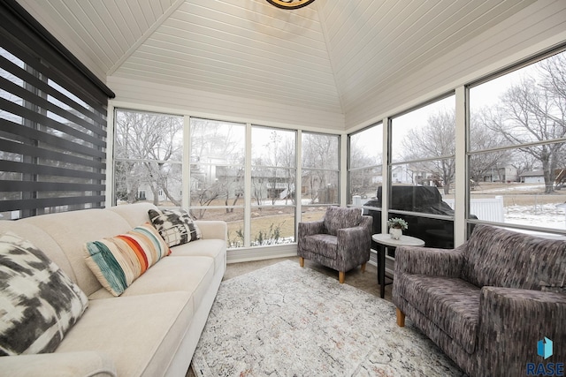 sunroom / solarium featuring lofted ceiling and plenty of natural light