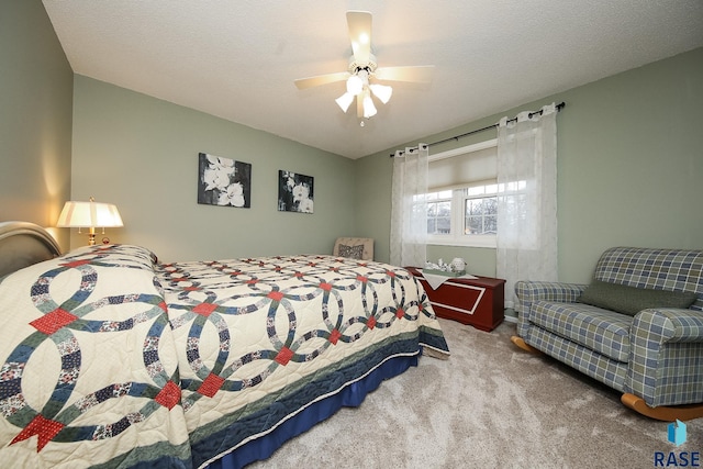 bedroom with carpet floors, a textured ceiling, and a ceiling fan