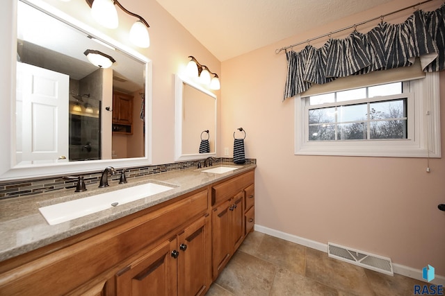 bathroom with double vanity, visible vents, decorative backsplash, and a sink