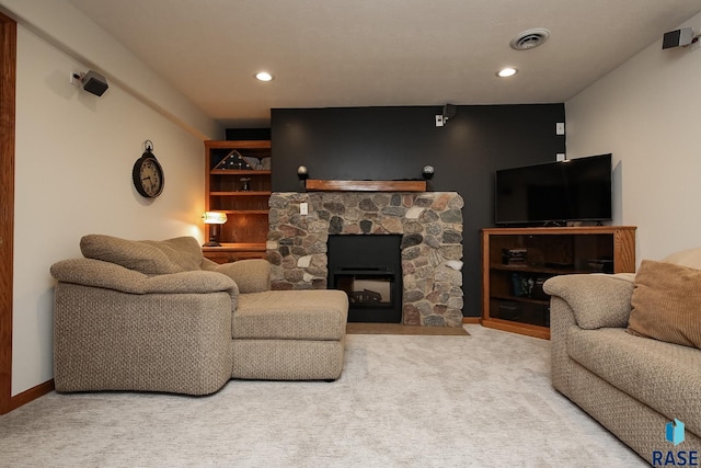 carpeted living room with baseboards, a fireplace, visible vents, and recessed lighting