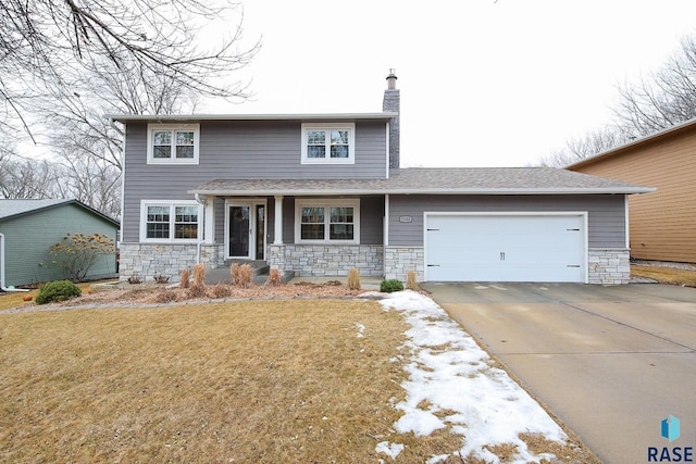 traditional-style house with a garage, stone siding, a chimney, and concrete driveway