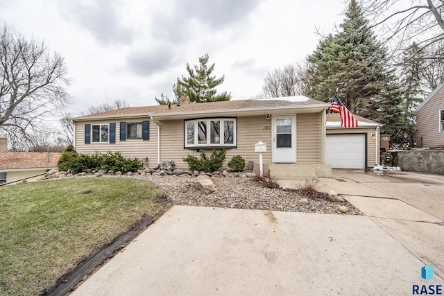 ranch-style home featuring driveway and a front yard