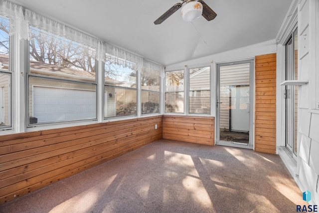 unfurnished sunroom featuring ceiling fan