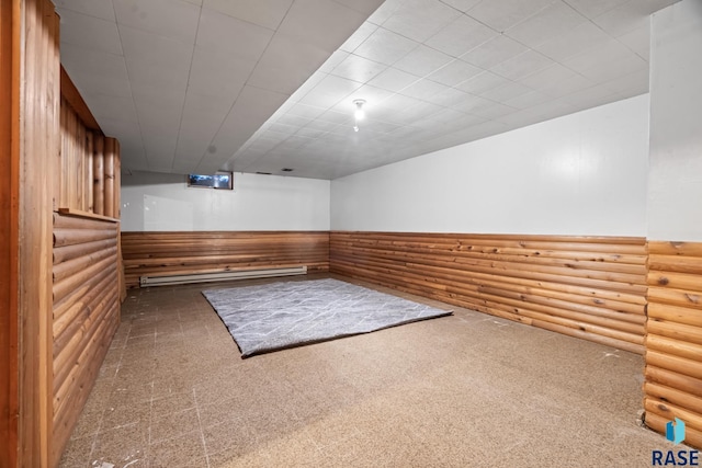 carpeted spare room with a wainscoted wall and log walls