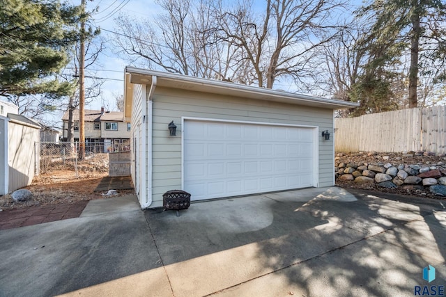 detached garage featuring fence