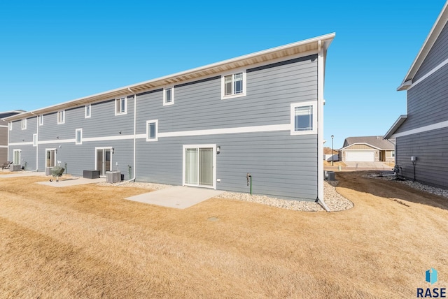 back of house with a patio area, a yard, and central AC unit