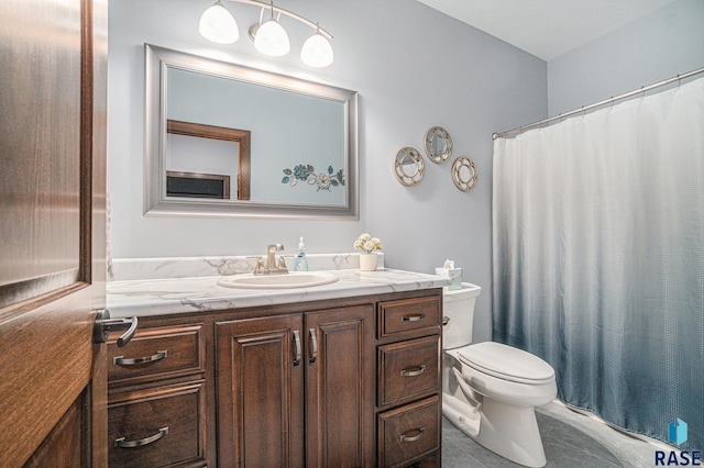 bathroom featuring curtained shower, vanity, and toilet