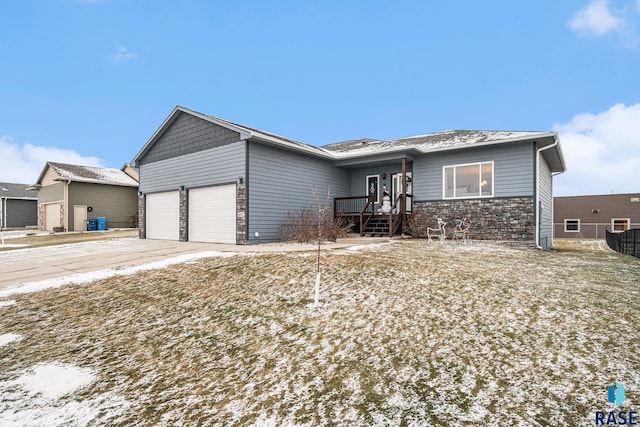 ranch-style home featuring a garage, stone siding, and driveway