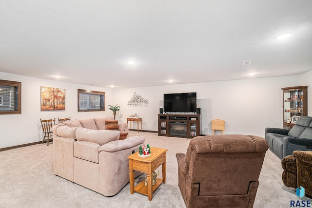 living area with recessed lighting, light carpet, and baseboards