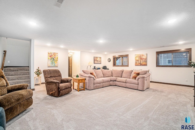 carpeted living room with baseboards, visible vents, stairs, a textured ceiling, and recessed lighting