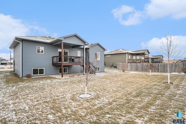 rear view of property featuring stairs and fence