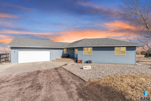 single story home with roof with shingles, driveway, an attached garage, and fence