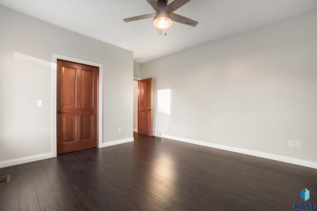 unfurnished bedroom with dark wood finished floors, visible vents, and baseboards