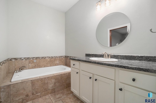 full bath featuring a garden tub and vanity