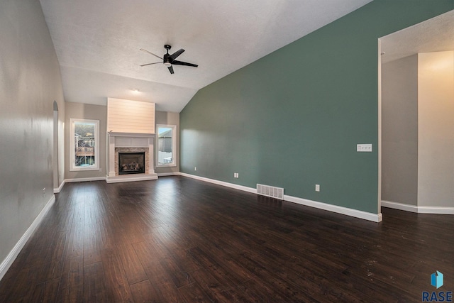 unfurnished living room featuring dark wood-style floors, baseboards, and a ceiling fan