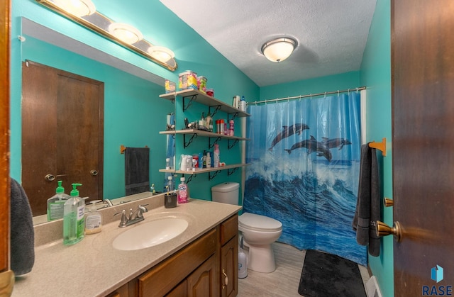 bathroom featuring curtained shower, toilet, a textured ceiling, vanity, and wood finished floors