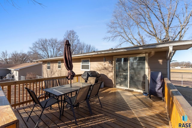 wooden deck featuring outdoor dining space