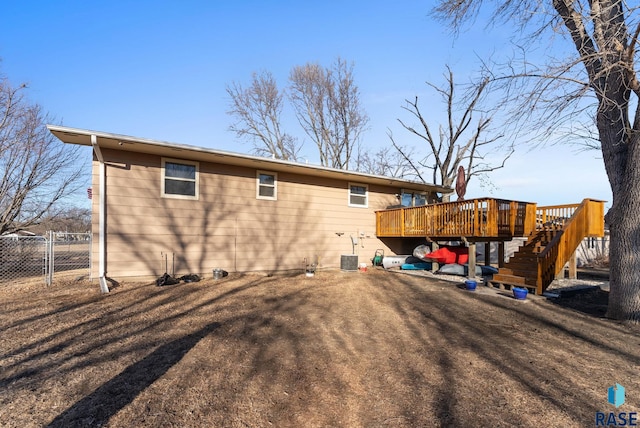 rear view of property featuring fence, a deck, and cooling unit