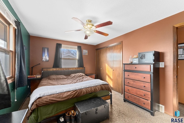 bedroom featuring baseboards, visible vents, ceiling fan, carpet flooring, and a closet