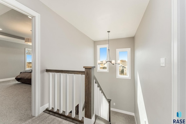 staircase featuring carpet floors and baseboards