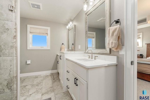 ensuite bathroom with visible vents, vanity, baseboards, and ensuite bathroom