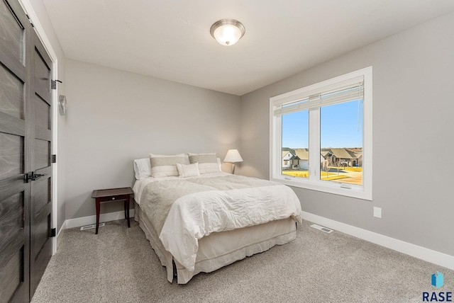 bedroom with visible vents, baseboards, and carpet flooring