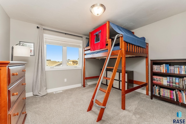 carpeted bedroom featuring visible vents and baseboards