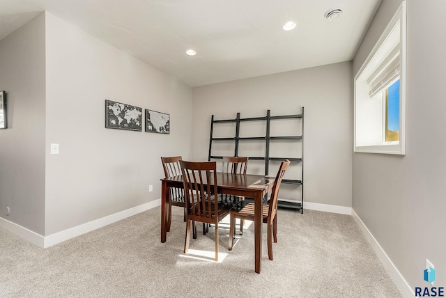 dining area featuring light carpet, baseboards, and recessed lighting