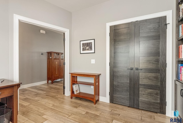 interior space featuring light wood-style flooring and baseboards