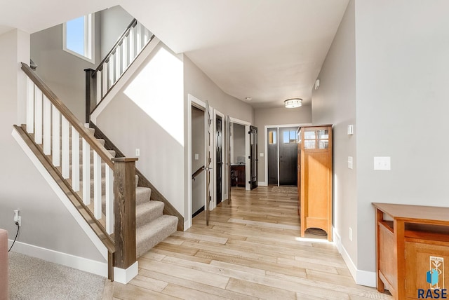 interior space featuring baseboards and wood finished floors