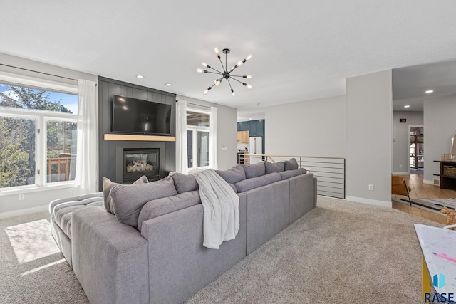 living area featuring a fireplace, recessed lighting, light colored carpet, a chandelier, and baseboards