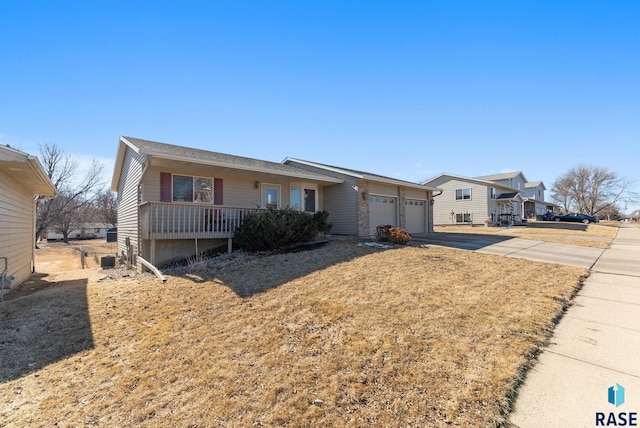 ranch-style house featuring an attached garage and concrete driveway