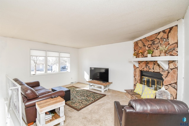 living area featuring a textured ceiling, a fireplace, visible vents, and carpet flooring