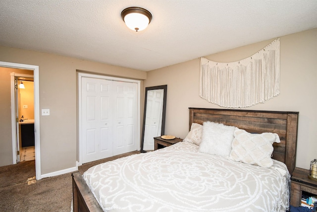 carpeted bedroom with a textured ceiling, baseboards, and a closet