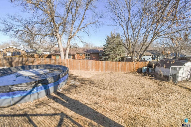 view of yard with a fenced in pool and fence