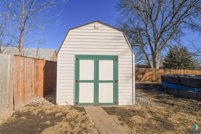 view of shed with a fenced backyard