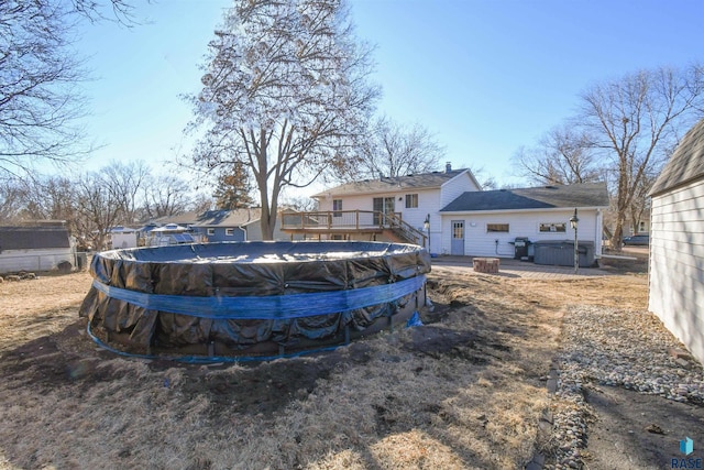 view of yard featuring a fenced in pool and a deck