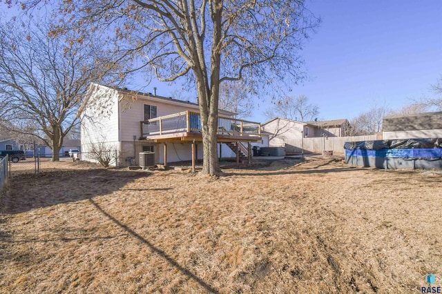 back of property featuring central AC, a fenced backyard, a wooden deck, and stairs