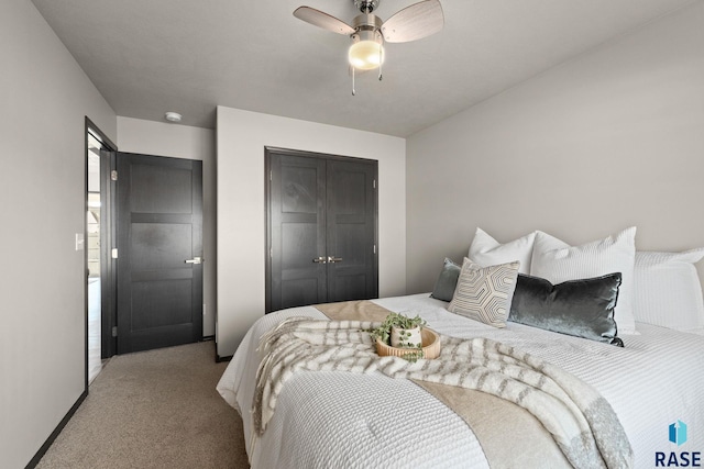 carpeted bedroom featuring a closet, a ceiling fan, and baseboards