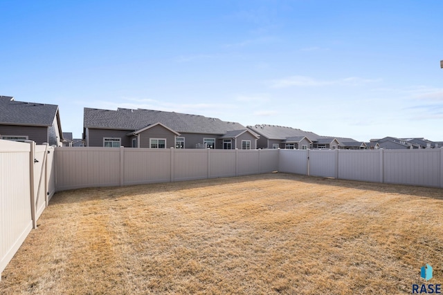 view of yard with a residential view and a fenced backyard