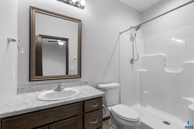 full bathroom with a shower, vanity, and toilet