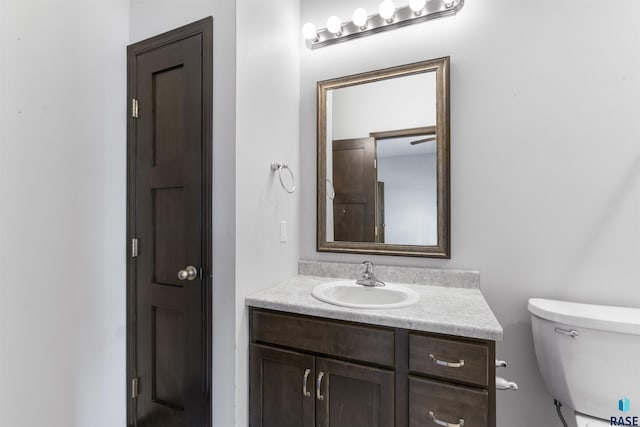 bathroom with toilet and vanity