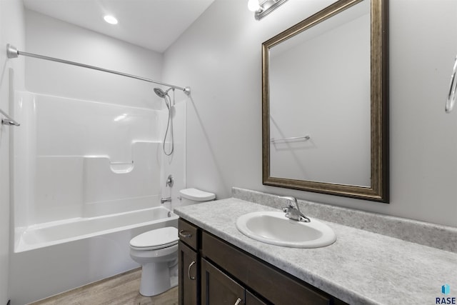 bathroom with bathing tub / shower combination, vanity, toilet, and wood finished floors