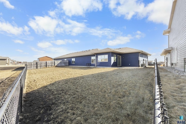 rear view of property with a fenced backyard