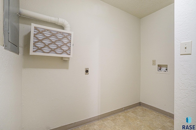 clothes washing area featuring hookup for an electric dryer, laundry area, washer hookup, baseboards, and electric panel