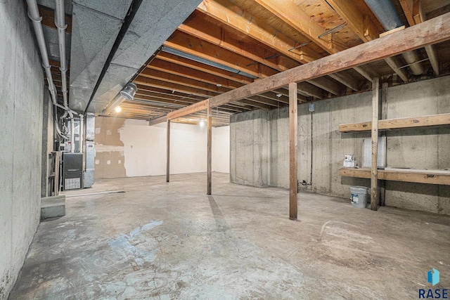 unfinished basement featuring heating unit