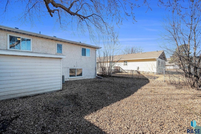 rear view of house with stucco siding