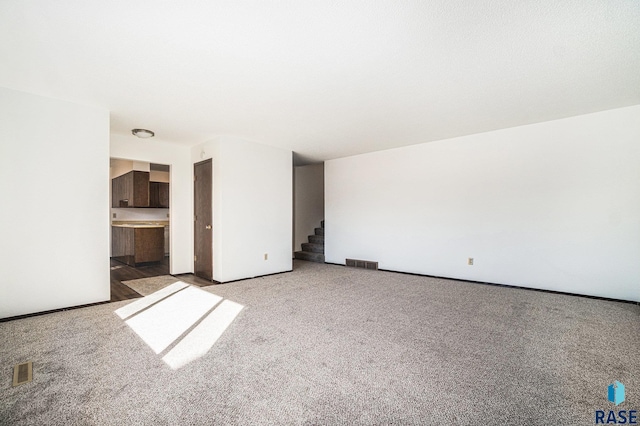 interior space with stairs, carpet, and visible vents